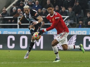 Newcastle United's Joelinton shoots as Manchester United's Raphael Varane.