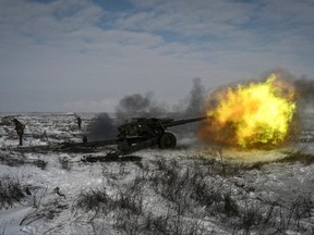 A Russian army service member fires a howitzer during drills at the Kuzminsky range in the southern Rostov region, Russia Jan. 26, 2022.