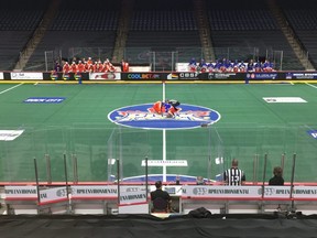 Halifax Thunderbirds' Jake Withers and TD Ierlan of the Toronto Rock battle for the opening faceoff in front of empty seats at the FirstOntario Centre in Hamiton. The game was closed to fans in accordance with provincial COVID-19 restrictions.