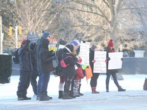 A small group of parents with their children in tow protested outside the Ontario Legislature on Monday January 3, 2022.
