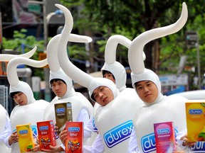 Sperm men who work for British condom maker Durex show condom samples during a campaign in Seoul on June 24, 2008 to mark the first sale of its products in South Korea.