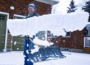 Pat O’Keefe gets to work after snow showers in Ajax on Sunday, Jan. 2, 2022. VERONICA HENRI/TORONTO SUN