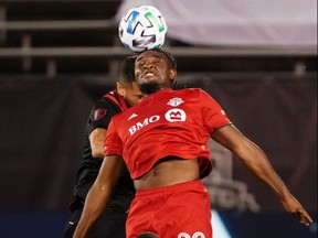 Toronto FC forward Ayo Akinola (20) headers the ball against the New York Red Bulls in the first half at Pratt and Whitney Stadium at Rentschler Field on Oct. 14, 2020.
