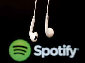 Headphones are seen in front of a logo of online music streaming service Spotify in this illustration picture taken in Strasbourg, Feb. 18, 2014.