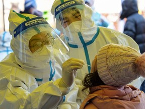 A resident undergoes a nucleic acid test for COVID-19 in north China's Tianjin on Jan. 10, 2022.