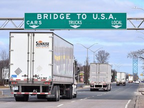 Transport trucks approach the Canada/USA border crossing in Windsor in this file photo from March 2020.