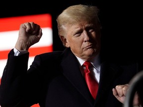 Former President Donald Trump gestures as he speaks during a rally, in Conroe, Texas, January 29, 2022.