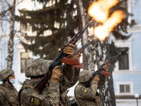 Service members fire a salute during a ceremony in tribute to fallen defenders of Ukraine, including the soldiers killed during a battle with pro-Russian rebels for the Donetsk airport this day in 2015, at a memorial near the headquarters of the Defence Ministry in Kyiv, Ukraine, Thursday, Jan. 20, 2022.