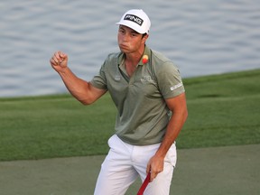 Viktor Hovland of Norway celebrates after winning the Dubai Desert Classic in a playoff on Sunday at Emirates Golf Club.