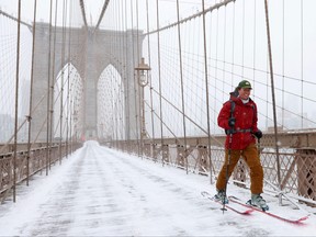 A person skis over the Brooklyn Bridge during a Nor'easter storm in New York City, U.S., Jan. 29, 2022.