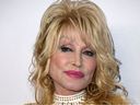 In this file photo taken on Feb. 8, 2019, Dolly Parton arrives for the 2019 MusiCares Person of the Year gala at the Los Angeles Convention Center.