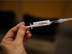 In this file photo taken on November 24, 2021 a nurse holds the Pfizer-BioNTech Covid-19 vaccine for children in Montreal, Quebec.