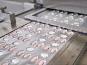 This file photo provided November 16, 2021, courtesy of Pfizer, shows the manufacture of its experimental COVID-19 antiviral pills, Paxlovid, in Freiburg, Germany.