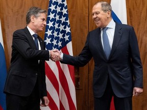US Secretary of State Antony Blinken and Russian Foreign Minister Sergey Lavrov shake hands before their meeting on January 21, 2022, in Geneva, Switzerland.