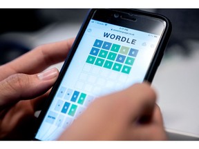In this file photo taken on January 11, 2022, this photo illustration shows a person playing online word game "Wordle" on a mobile phone in Washington, DC.