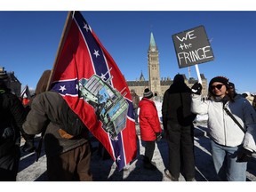 A supporter carries a U.S. Confederate flag during the Freedom Convoy protesting COVID-19 vaccine mandates and restrictions in front of Parliament on Jan. 29, 2022 in Ottawa.