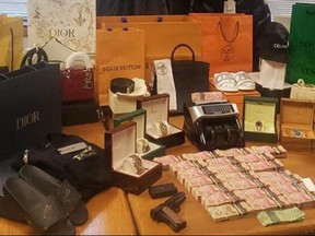Toronto Police executed a search warrant as part of a suspected online fraud scheme and allegedly seized a handgun with ammunition, a Winchester air pistol, over $221,000 in cash, an undisclosed amount of cocaine, and a large quantity of high-end clothing and watches.