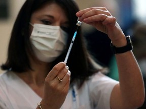 A medical worker prepares a coronavirus disease (COVID-19) vaccine as Israel kicks off a coronavirus vaccination drive, at Tel Aviv Sourasky Medical Center (Ichilov Hospital) in Tel Aviv, Israel December 20, 2020.