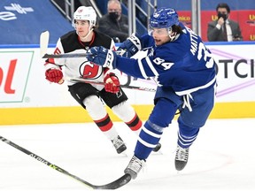 Toronto Maple Leafs forward Auston Matthews shoots the puck to score his first goal against New Jersey Devils in the first period at Scotiabank Arena.