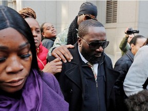 FILE PHOTO: Michael Thomas (C) departs after a court hearing regarding his actions the evening that led to the death of Jeffrey Epstein, outside a federal court in New York City, U.S., November 25, 2019.