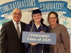 Sawsan Ahmed, centre, with her parents after graduating from Florida's Broward College at the age of 12.
