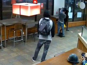 Police have released security video of a person wanted after a man repeatedly stabbed a stranger in the Harbour Centre Tim Hortons on Saturday.