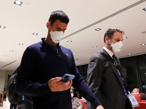 Serbian tennis player Novak Djokovic walks through Melbourne airport before boarding a flight, after the Federal Court upheld the government's decision to revoke his visa to play at the Australian Open, in Melbourne, Australia, January 16, 2022.