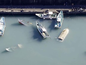 An aerial view shows capsized boats believed to be affected by the tsunami caused by an underwater volcano eruption on the island of Tonga at the South Pacific, in Muroto, Kochi prefecture, Japan, in this photo taken by Kyodo January 16, 2022.