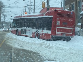 A TTC bus is stuck in the snow near the intersection of Gerrard St. E. and Coxwell Ave. on Monday, Jan. 17, 2022