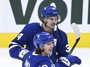 Toronto Maple Leafs forward Mitch Marner (bottom) celebrates with teammate Auston Matthews.
