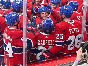 Cole Caufield #22 of the Montreal Canadiens celebrates his overtime goal with teammates against the St. Louis Blues at Centre Bell on February 17, 2022 in Montreal.  The Montreal Canadiens defeated the St. Louis Blues 3-2 in overtime.