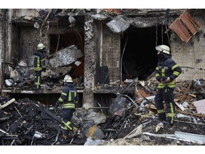 Feuerwehrleute löschen am 25. Februar 2022 in Kiew ein Feuer in einem Wohngebäude, das durch eine Rakete beschädigt wurde.