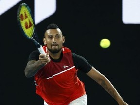 Nick Kyrgios of Australia plays a forehand in his Men's Doubles Final match with Thanasi Kokkinakis of Australia against Matthew Ebden of Australia and Max Purcell of Australia during day 13 of the 2022 Australian Open at Melbourne Park on January 29, 2022 in Melbourne, Australia.