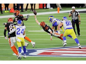 Joe Burrow #9 of the Cincinnati Bengals is sacked by Aaron Donald #99 of the Los Angeles Rams in the fourth quarter during Super Bowl LVI at SoFi Stadium on February 13, 2022 in Inglewood, California.