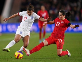 Nikita Parris of England is tackled by Jessie Fleming of Canada during the Arnold Clark Cup match between England and Canada at Riverside Stadium on February 17, 2022 in Middlesbrough, England.