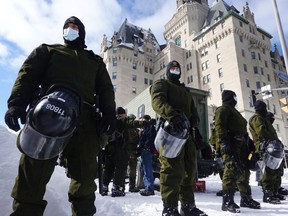 Police begin to break up a protest organized by truck drivers opposing vaccine mandates, in Ottawa, Feb. 18, 2022.