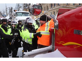 Police face off with demonstrators participating in a protest organized by truck drivers opposing vaccine mandates on February 19, 2022 in Ottawa.