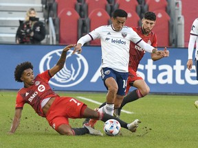 Toronto FC midfielder Jahkeele Marshall-Rutty challenges a D.C. United player.