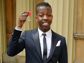 Jamal Edwards holds his Member of the British Empire (MBE), after it was awarded to him by the Prince of Wales at an Investiture Ceremony at Buckingham Palace on March 26, 2015 in London.