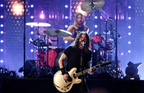 Dave Grohl and Taylor Hawkins of the Foo Fighters are seen performing after the band was inducted into the Rock and Roll Hall of Fame in 2021.