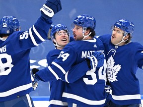 Maple Leafs forward Mitchell Marner (16) celebrates a goal against New Jersey Devils with forwards Auston Matthews (34) and Michael Bunting (58) and defenceman Timothy Liljegren