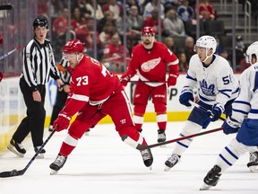 Leafs' Michael Bunting (right) keeps an eye on Adam Erne of the Red Wings last night in Detroit.