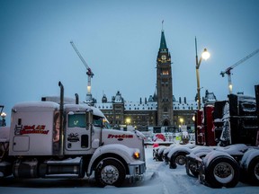 Trucks block a street in front of Parliament Hill during the protest against COVID-19 mandates, in Ottawa on Friday, Feb. 18, 2022.