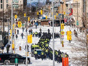 Police deploy to clear demonstrators against COVID-19 mandates in Ottawa on February 18, 2022.