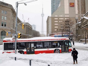 A TTC bus is pictured stuck since the morning hours in downtown Toronto after a major blizzard  on January 17, 2022.