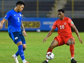 El Salvador's defender Ronald Gomez (L) vies for the ball with Canada's forward Jonathan David during the FIFA World Cup Concacaf qualifier football match between El Salvador and Canada at Cuscatlan Stadium in San Salvador on February 2, 2022.
