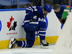 A Maple Leafs trainer checks on injured forward Auston Matthews during the third period against the Carolina Hurricanes on Monday night at Scotiabank Arena. Matthews left the game with a head injury but was at Toronto's practice on Tuesday and appears to be okay.