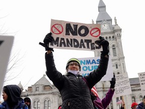 People attend a rally to stop the mask mandate in New York State Schools in Buffalo, Friday, Feb. 11, 2022.