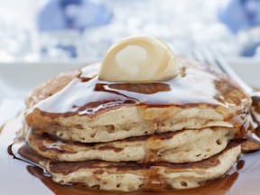 Fresh buttermilk pancakes with scoop of butter and maple syrup
