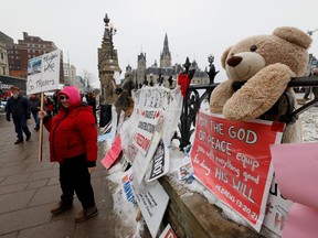 Demonstrators gather in front of Parliament Hill as truckers and their supporters continue to protest against COVID-19 vaccine mandates, in Ottawa, Feb. 8, 2022.